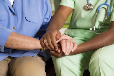 Doctor and patient clasping hands